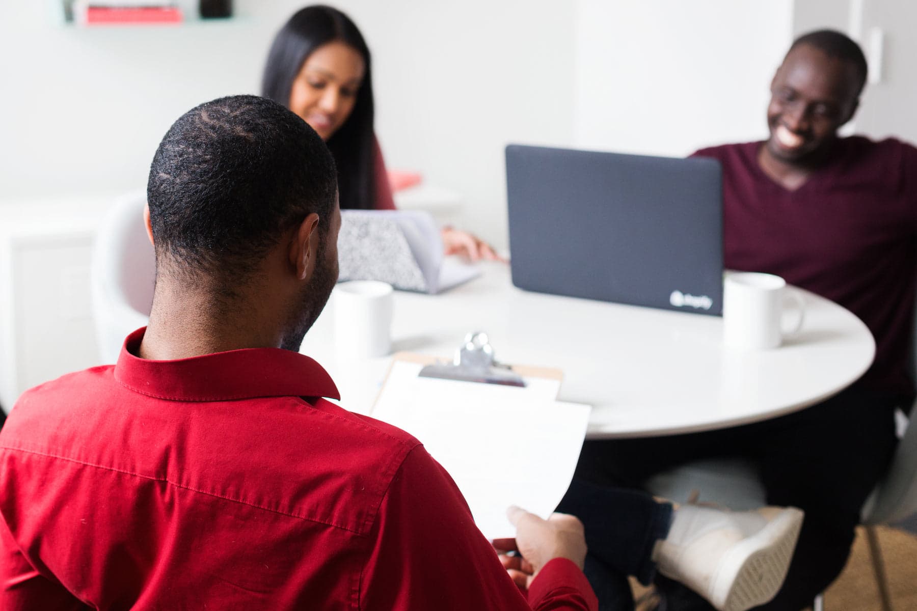 Colleagues working side by side around a table in an office