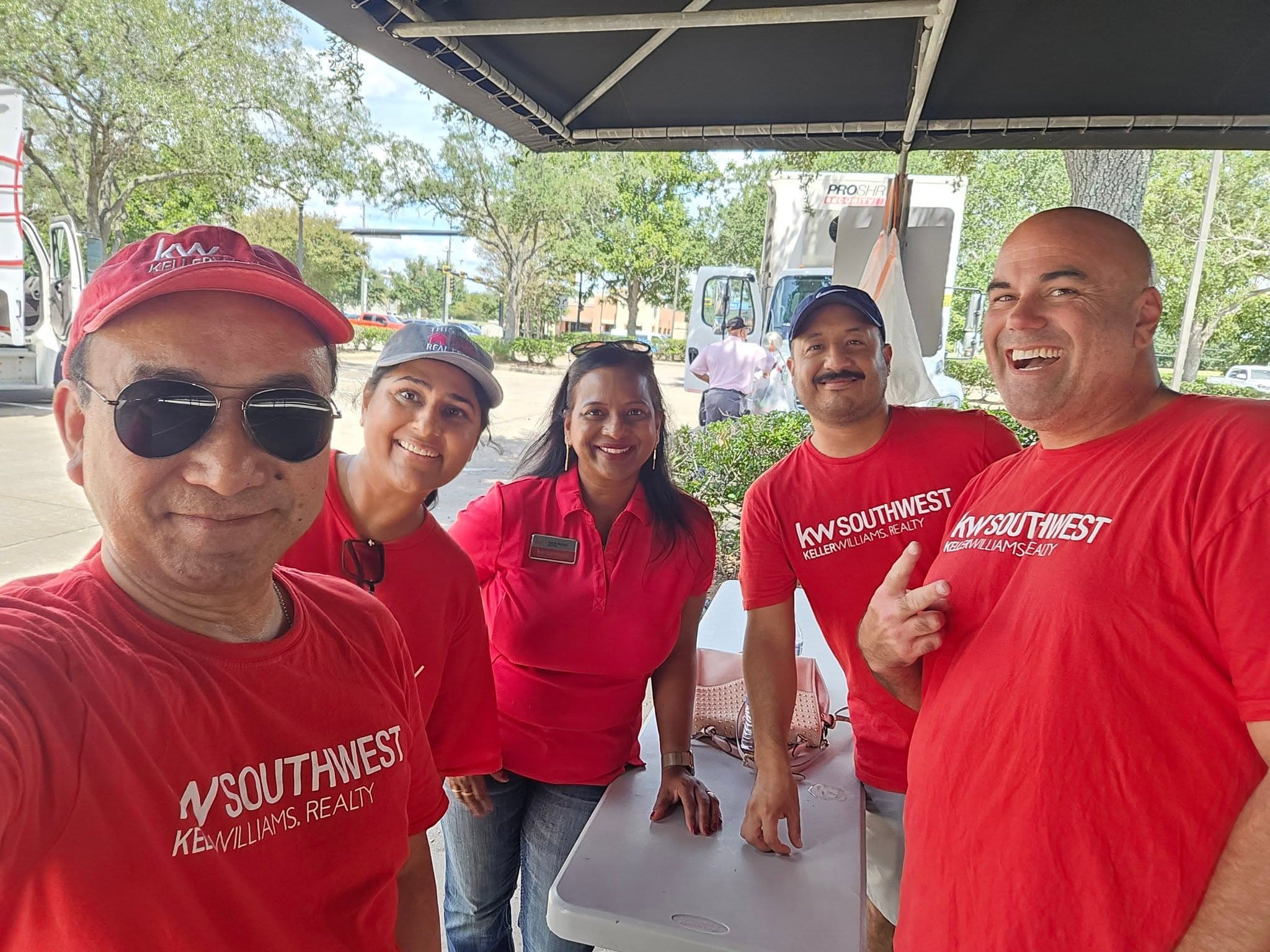 KW Southwest agents at the check-in tent with the PROSHRED truck behind them
